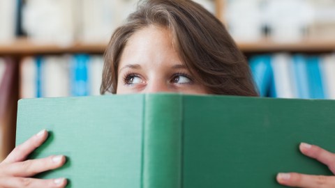Female student holding a book about how ADHD is real.