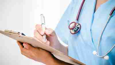 A doctor filling out a medication monitoring form