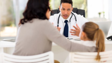 A doctor explains ADHD symptoms and solutions to avoiding homework stress to a family.