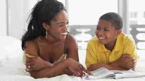 A mother bonds with her son by spending time reading together which improves understanding and lowers homework stress.