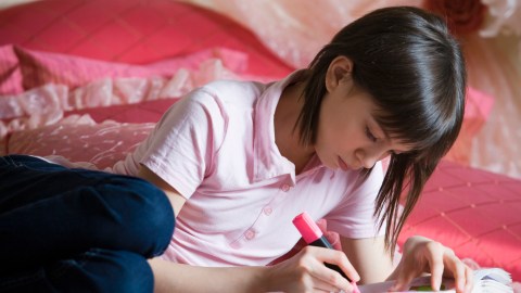 A student highlights important reading passages, a good strategy for relieving homework stress.