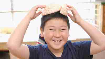 A boy in the science lab at school, smiling happily and experiencing no anxiety