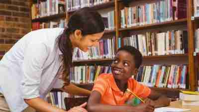 A tutor, which should be arranged before school starts, is helping a student with his homework.