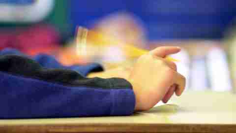 A student fidgeting during a test which 504 accomodations for adhd can help ease and mitigate.
