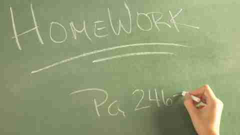 A teacher assigning homework on the blackboard, which 504 accomodations for adhd can help your child to complete by improving communication.