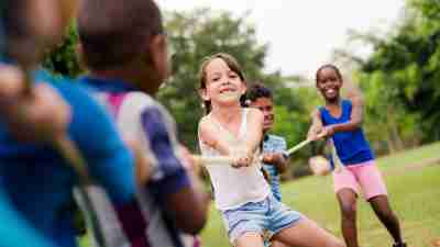 Children playing tug-of-war at a summer camp for kids with ADHD