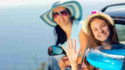 A mother and daughter at the beach, on a summer schedule