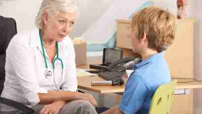 A young boy receiving a misdiagnosis of ADHD from an older doctor