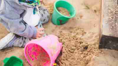 Child with EFD playing in sandbox