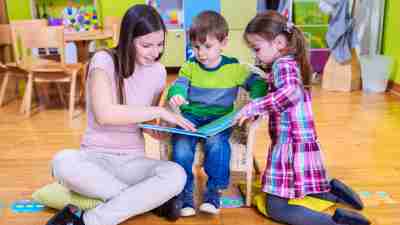 Kindergarten Teacher and Two ADHD Kids Reading a Book