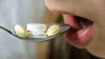 Child with ADHD taking spoonful of medication